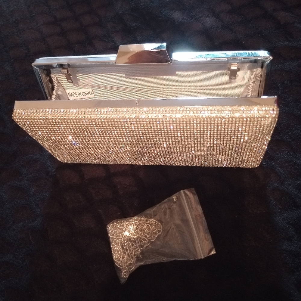 Stunning rhinestone clutch / purse with silver metallic on other side.